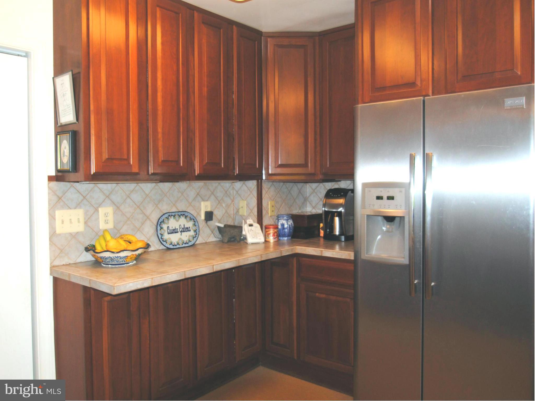 7921 Bainbridge Road Alexandria, VA 22308 - Photo 10 of 30 a kitchen with stainless steel appliances granite countertop a refrigerator and a sink