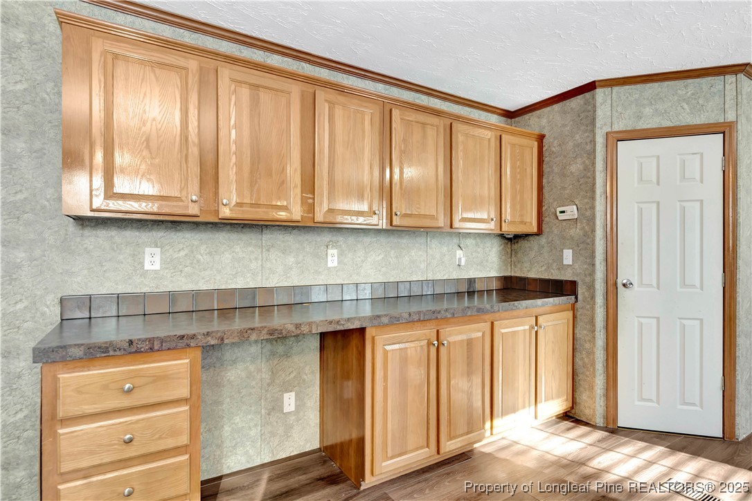 193 Fork Pine Road Lumberton, NC 28358 - Photo 11 of 40 a kitchen with granite countertop wooden cabinets and a sink
