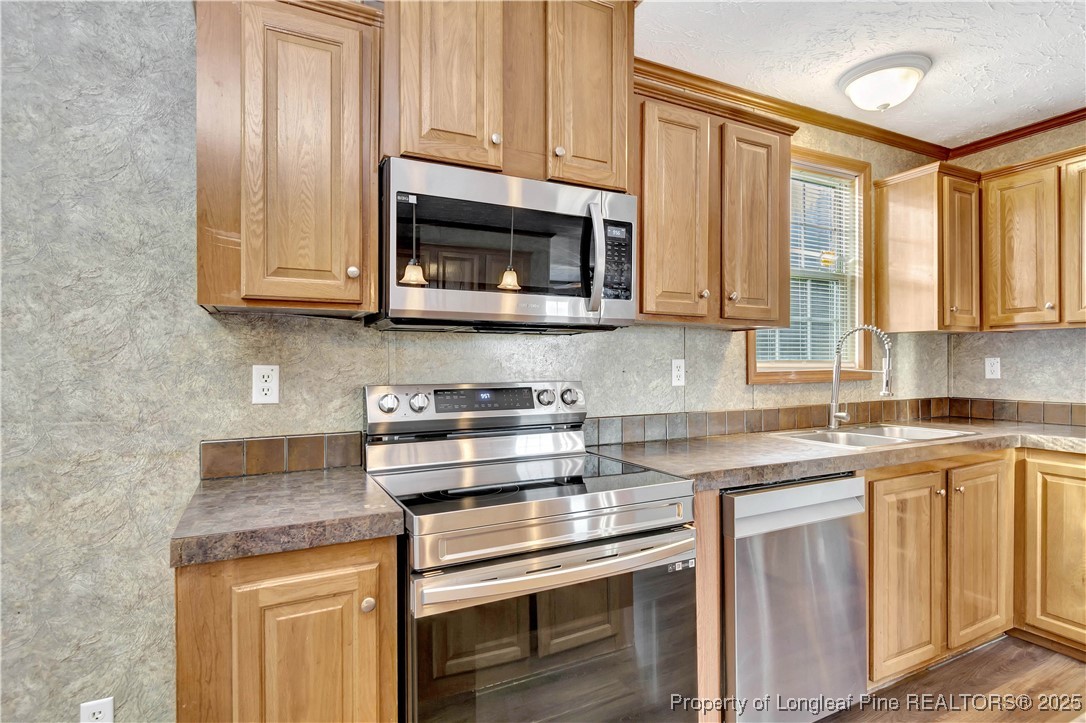 193 Fork Pine Road Lumberton, NC 28358 - Photo 12 of 40 a kitchen with stainless steel appliances granite countertop a stove a sink and a microwave