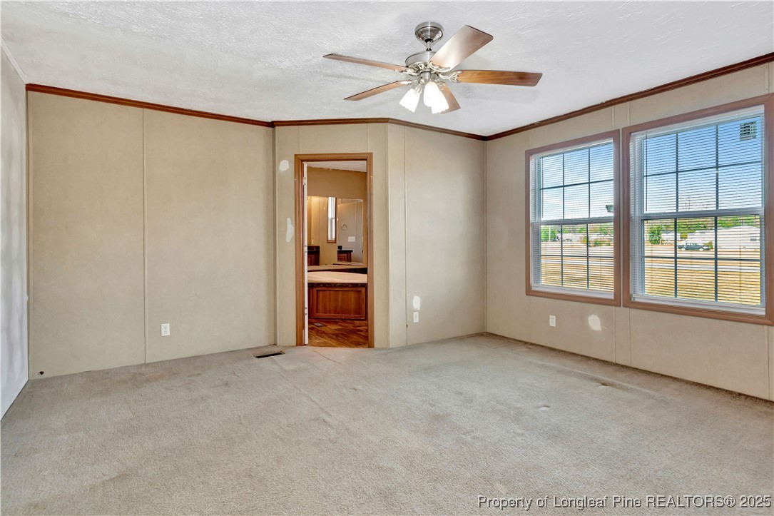 193 Fork Pine Road Lumberton, NC 28358 - Photo 23 of 40 an empty room with chandelier fan and windows