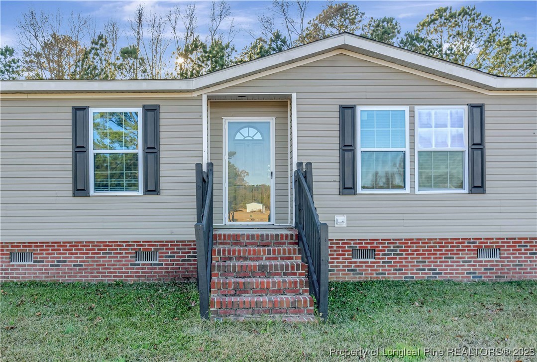 193 Fork Pine Road Lumberton, NC 28358 - Photo 4 of 40 a front view of a house with a garden