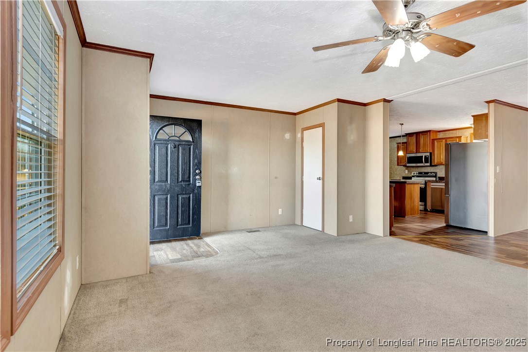193 Fork Pine Road Lumberton, NC 28358 - Photo 6 of 40 a view of a livingroom with a chandelier fan and windows