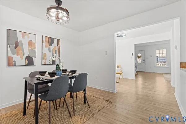 a dining room with furniture and wooden floor