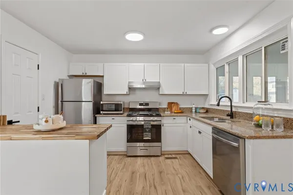 a kitchen with a sink stove and refrigerator