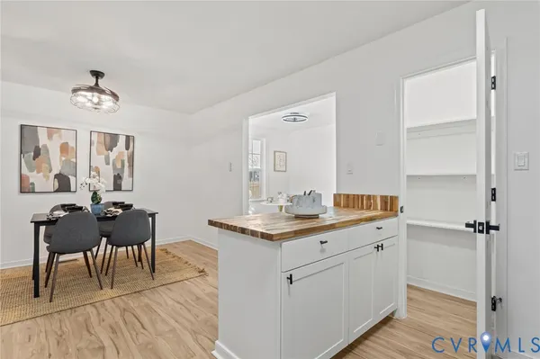 a kitchen with a sink cabinets and wooden floor