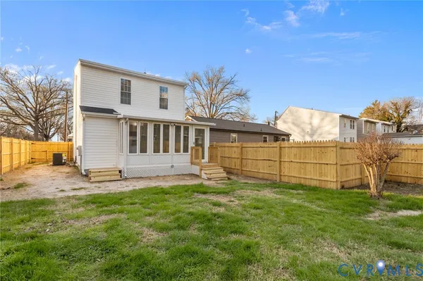 a view of a house with a yard and sitting area
