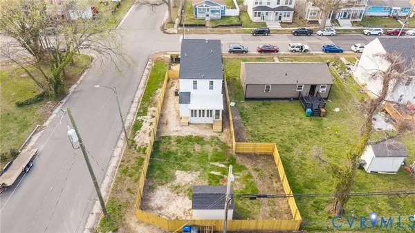 a view of a house with backyard and trees