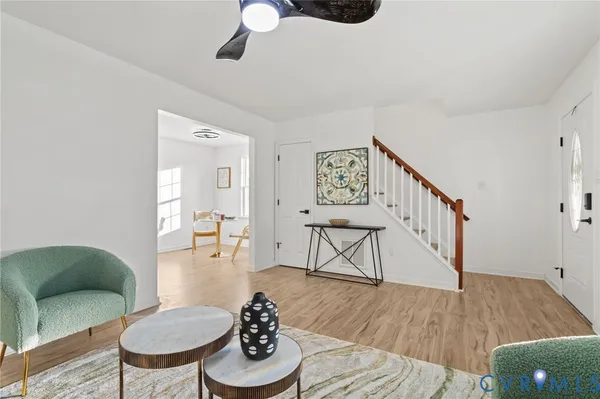 a living room with furniture and a wooden floor