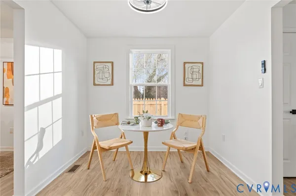 a dining room with furniture and wooden floor