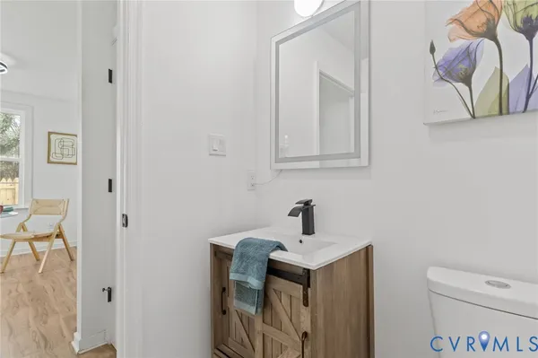 a bathroom with a toilet sink and mirror