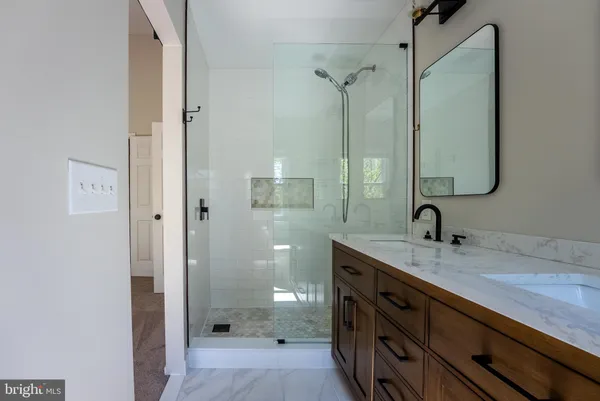 a bathroom with a granite countertop sink mirror and double