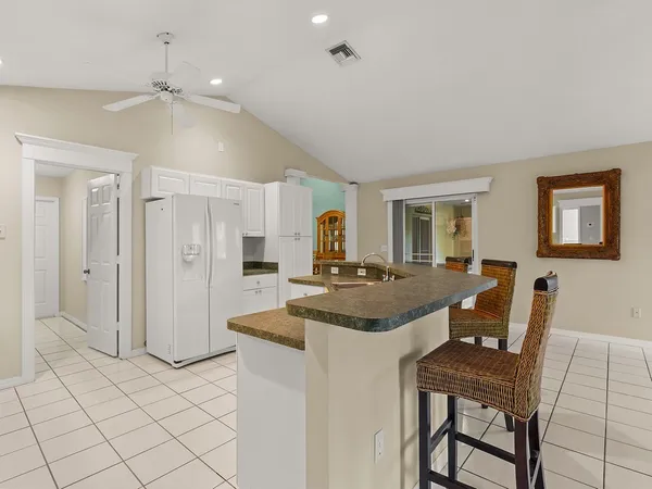 a view of a a dining room with furniture and a chandelier