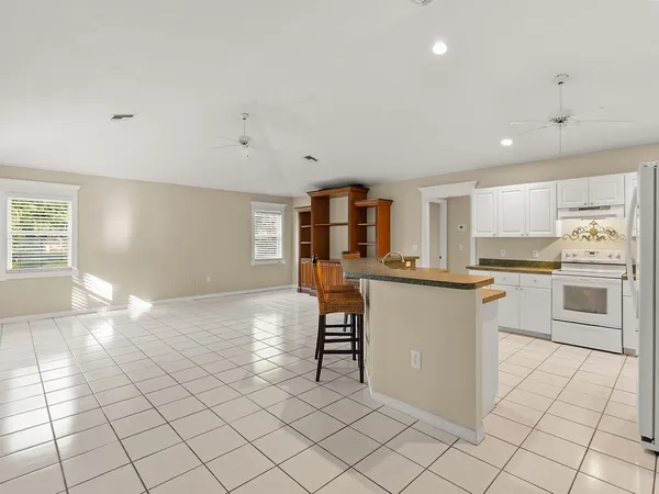 a kitchen with white cabinets and appliances