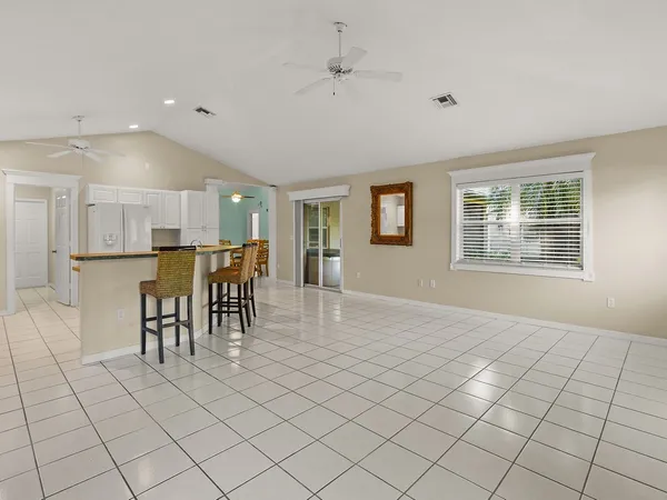 a view of kitchen with furniture and refrigerator