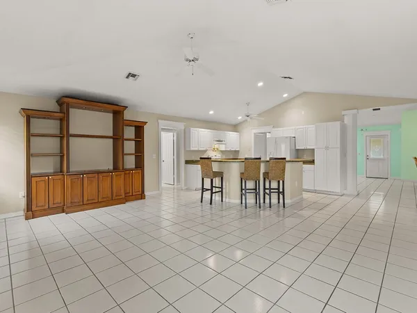 a view of a livingroom with furniture and a window