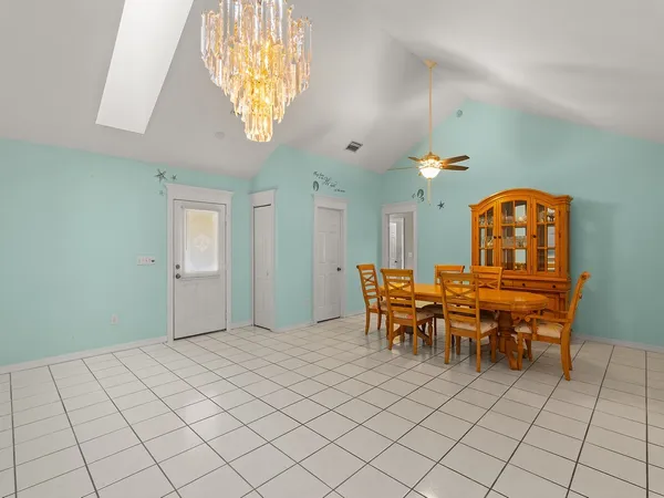 a view of a dining room with furniture and chandelier