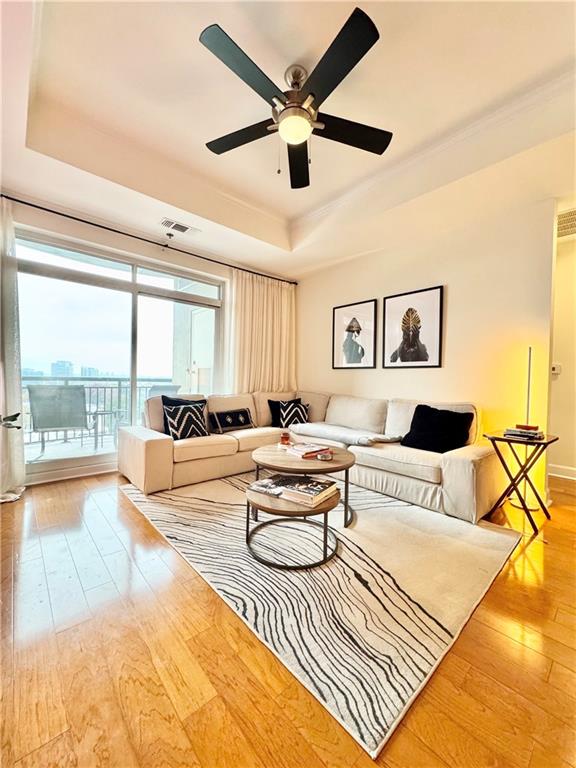 325 East Paces Ferry Road Northeast, Unit 1701 Atlanta, GA 30305 - Photo 12 of 46 a living room with furniture and a large window