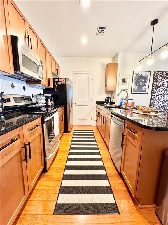 325 East Paces Ferry Road Northeast, Unit 1701 Atlanta, GA 30305 - Photo 19 of 46 a kitchen with stainless steel appliances a stove a sink and a refrigerator