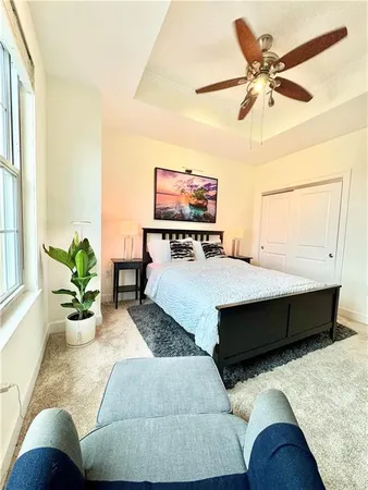 a bedroom with a large bed and a chandelier