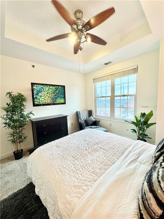 325 East Paces Ferry Road Northeast, Unit 1701 Atlanta, GA 30305 - Photo 29 of 46 a bedroom with a large bed and a chandelier