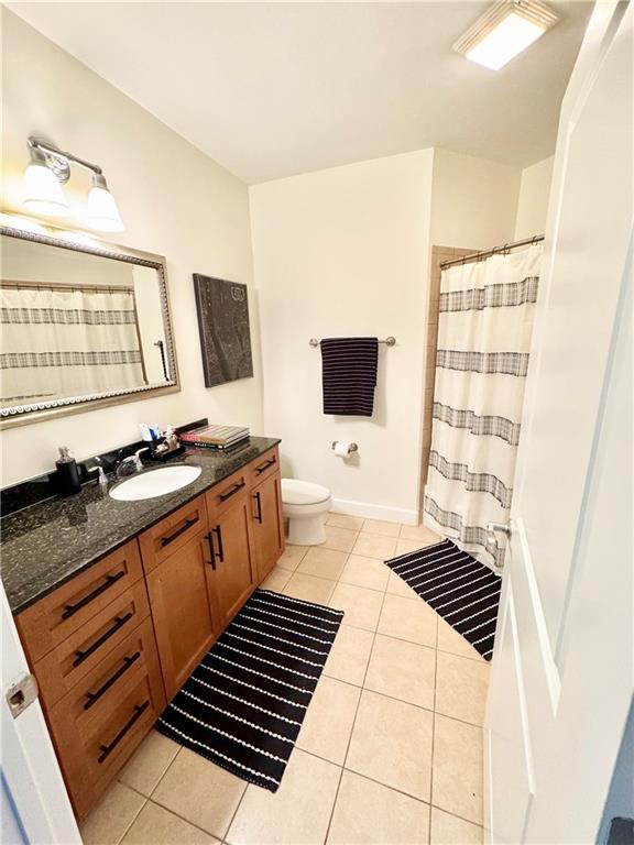 325 East Paces Ferry Road Northeast, Unit 1701 Atlanta, GA 30305 - Photo 30 of 46 a kitchen with granite countertop a stove a sink and a microwave