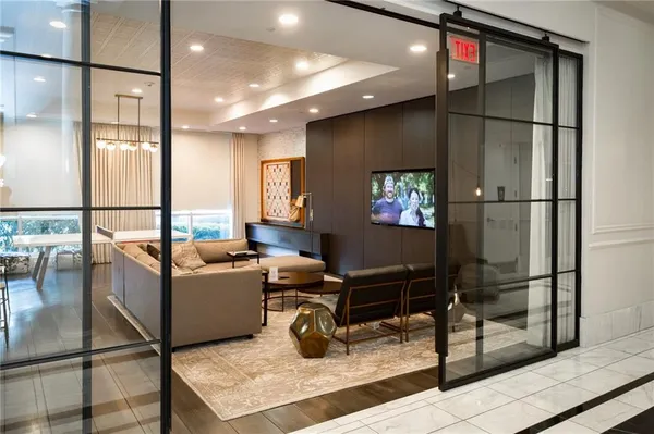 a living room with furniture a rug and white walls