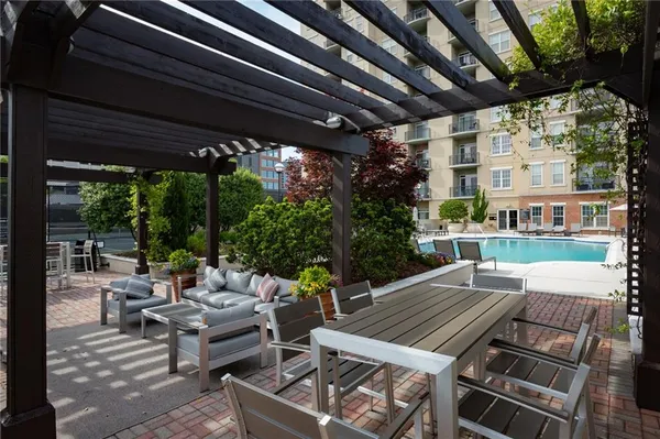 a patio with a table and chairs under an umbrella