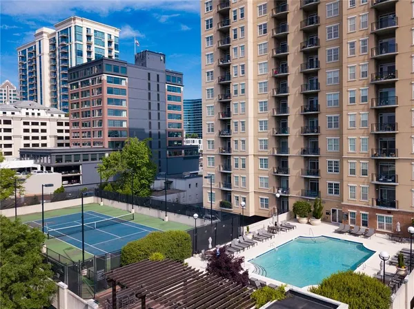 a view of a swimming pool with outdoor seating and plants