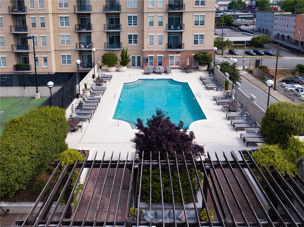 325 East Paces Ferry Road Northeast, Unit 1701 Atlanta, GA 30305 - Photo 40 of 46 a view of a swimming pool with outdoor seating and plants