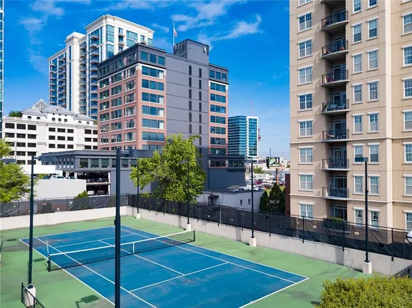 a swimming pool with outdoor seating and city view