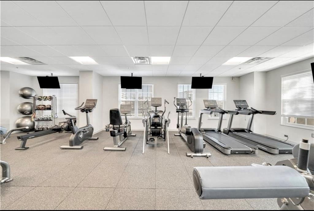 325 East Paces Ferry Road Northeast, Unit 1701 Atlanta, GA 30305 - Photo 43 of 46 a room with gym equipment and a large window