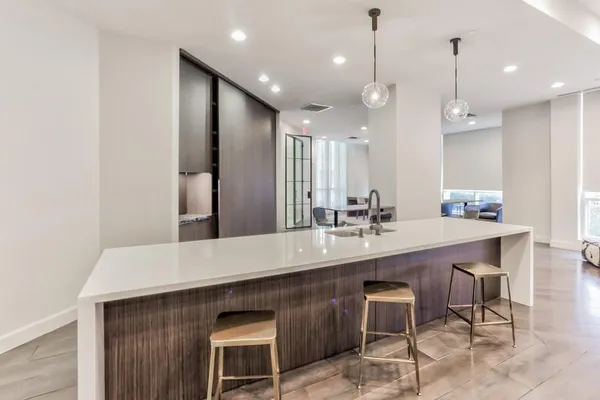 a living room with furniture a rug and a chandelier
