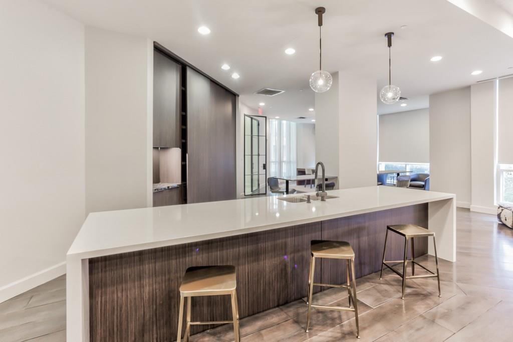 325 East Paces Ferry Road Northeast, Unit 1701 Atlanta, GA 30305 - Photo 8 of 46 a large kitchen with a table and chairs in it