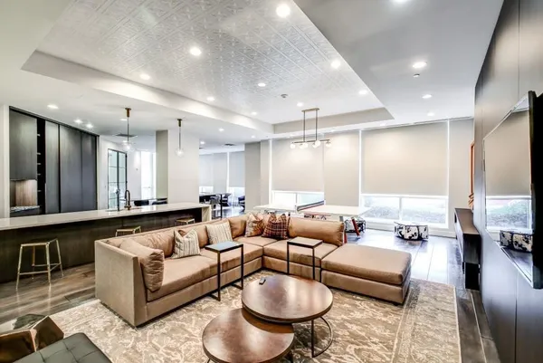 a living room with furniture and a table with wooden floor