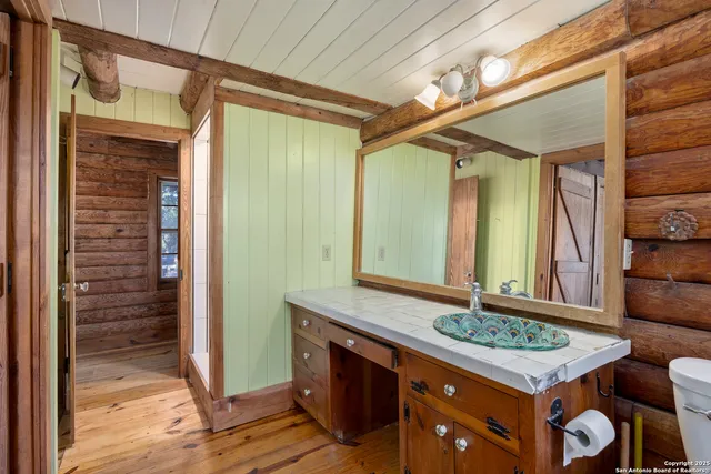 a bathroom with a sink a vanity and a mirror