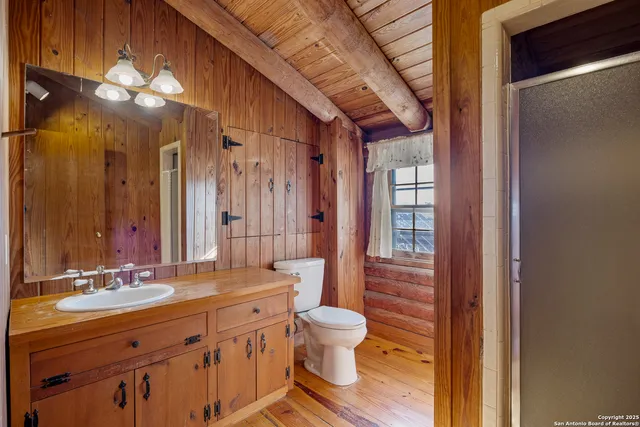 a bathroom with a double vanity sink mirror and toilet