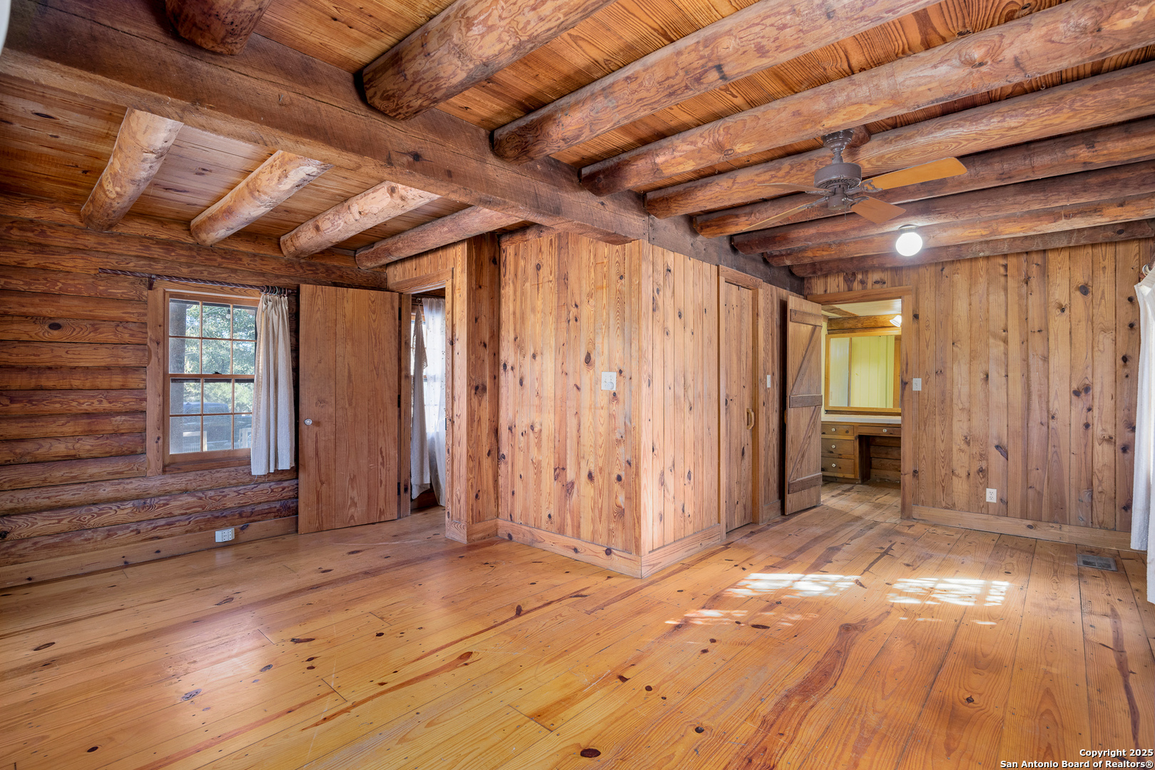 387 Schmidtzinsky Road Fredericksburg, TX 78624 - Photo 10 of 37 a view of an empty room with wooden floor and entryway