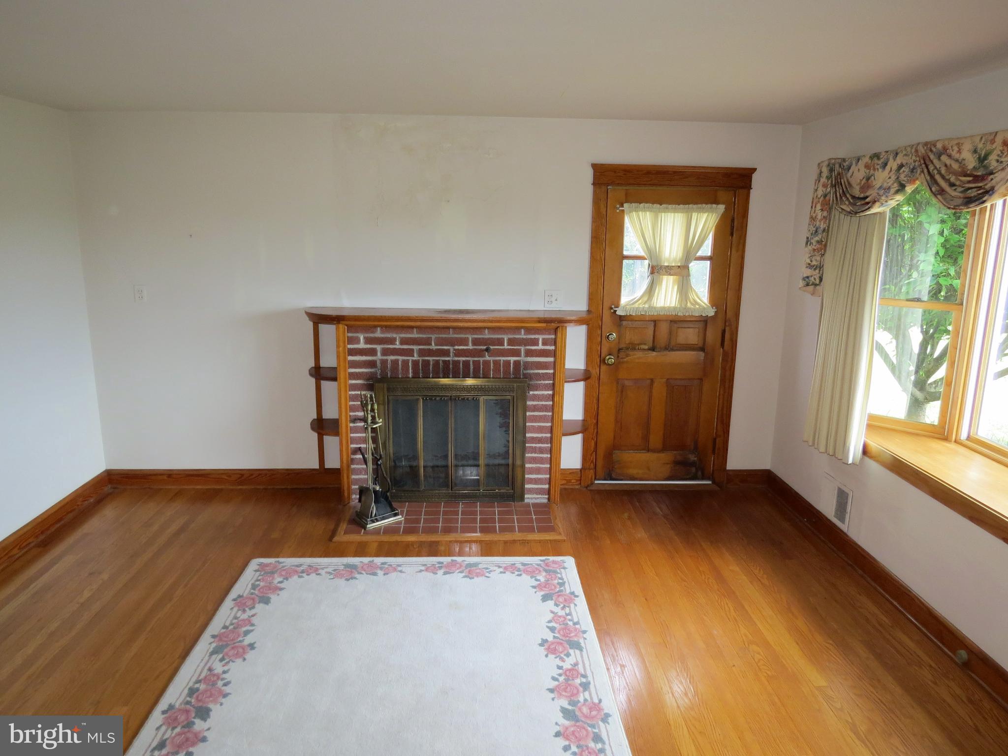 4418 Upper Beckleysville Road Hampstead, MD 21074 - Photo 13 of 25 a view of an empty room with a fireplace and a window