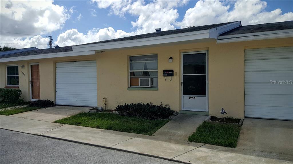 4944 Elkner Street, Unit 4944 New Port Richey, FL 34652 - Photo 1 of 1 a front view of a house with a garden