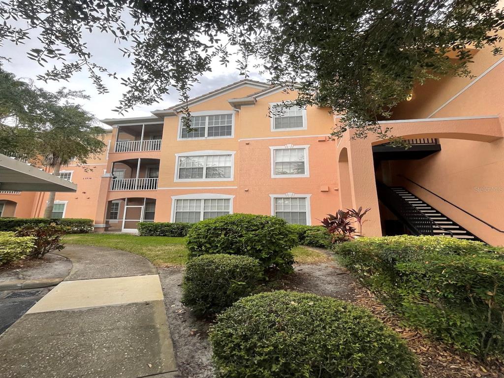 a front view of a house with a yard and trees