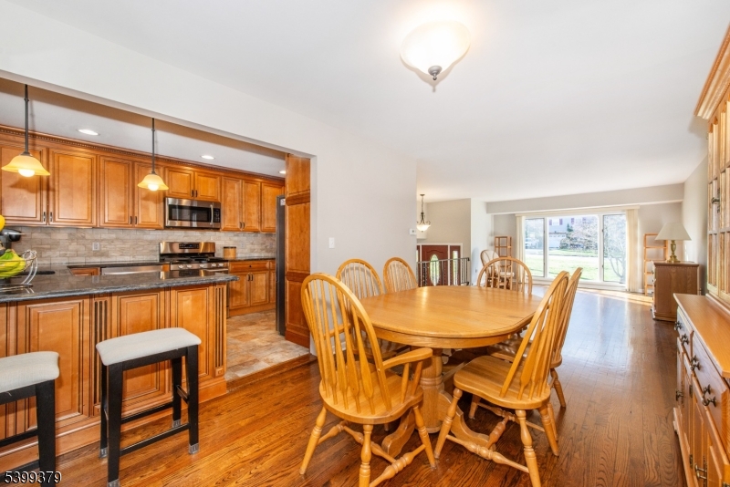 21 Dolly Road Parsippany, NJ 07054 - Photo 11 of 35 a dining room with furniture wooden floor and a kitchen view
