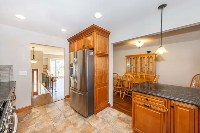 a kitchen with stainless steel appliances granite countertop a refrigerator and a sink