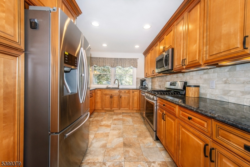 21 Dolly Road Parsippany, NJ 07054 - Photo 14 of 35 a kitchen with stainless steel appliances granite countertop a refrigerator and a sink