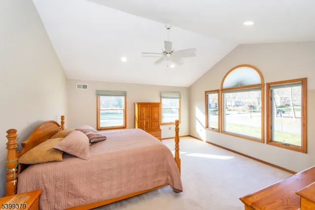 a bedroom with a large bed and a large window