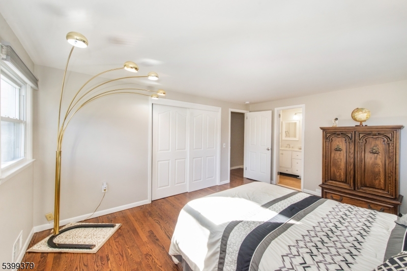 21 Dolly Road Parsippany, NJ 07054 - Photo 22 of 35 a bedroom with a bed and a chandelier