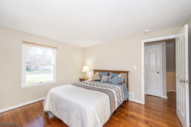 21 Dolly Road Parsippany, NJ 07054 - Photo 24 of 35 a bedroom with a bed and wooden floor
