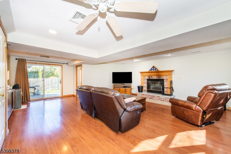 21 Dolly Road Parsippany, NJ 07054 - Photo 3 of 35 a living room with furniture a flat screen tv and a large window