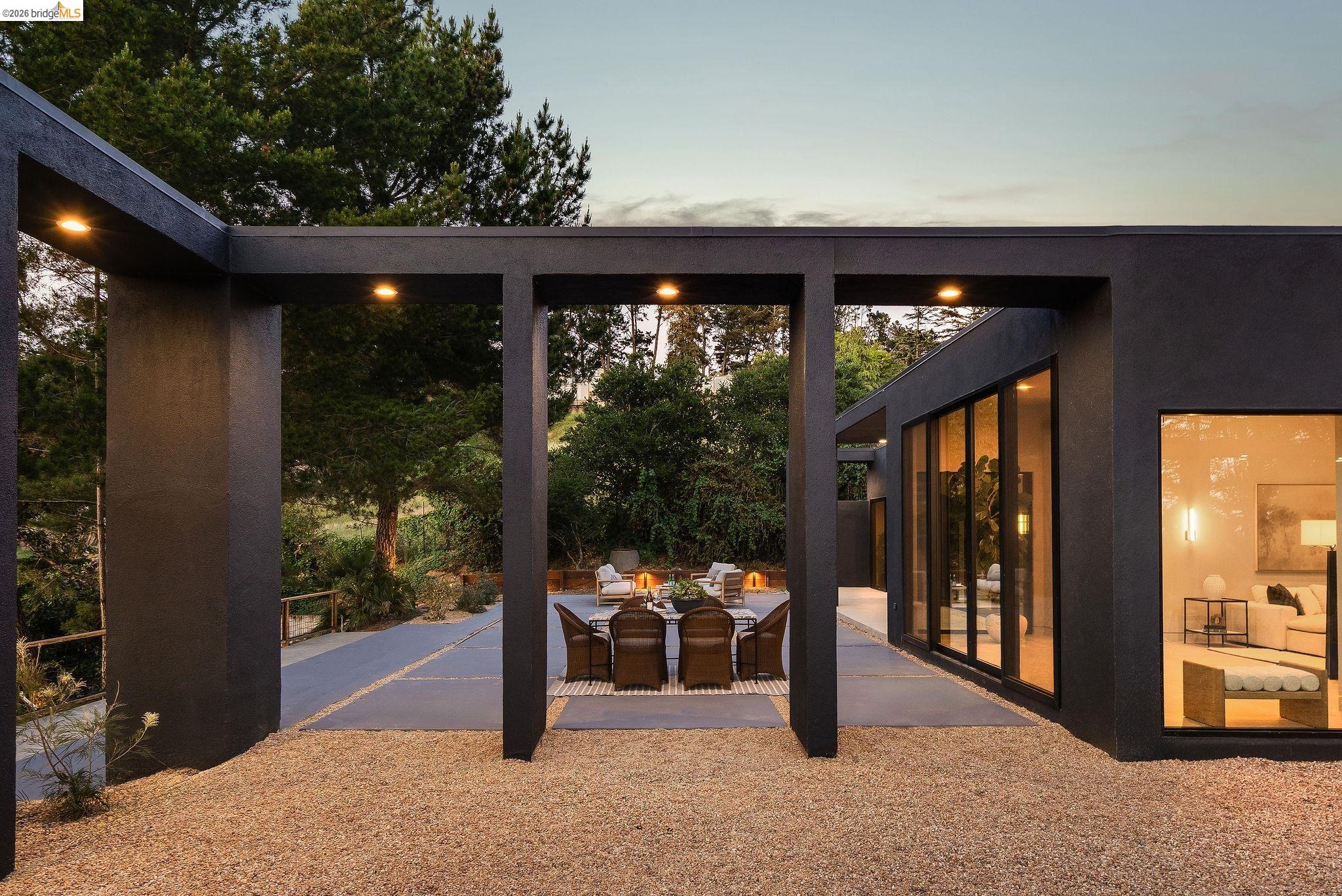 5645 Bacon Road Oakland, CA 94619 - Photo 87 of 94 Contemporary exterior featuring dark-toned stucco, extensive glass doors, and large picture windows
