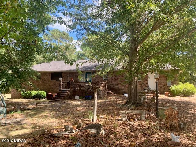 3229 Hamlin Road Lizella, GA 31052 - Photo 4 of 23 a backyard of a house with yard and outdoor seating