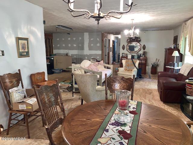 3229 Hamlin Road Lizella, GA 31052 - Photo 6 of 23 a living room with furniture and a chandelier
